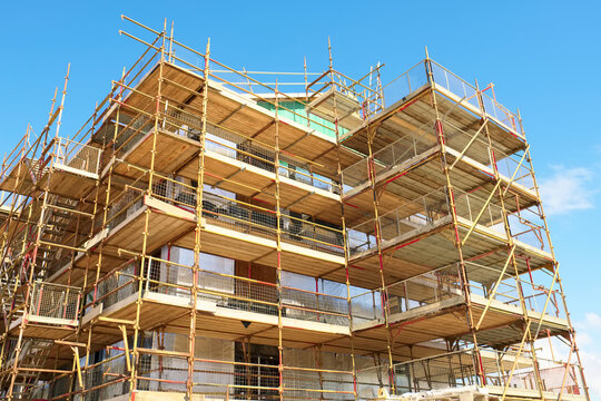 Scaffolding surrounding house development for safe access to construction work