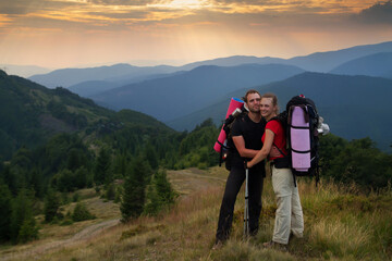 Young male and female tourists on a walk in the mountains 