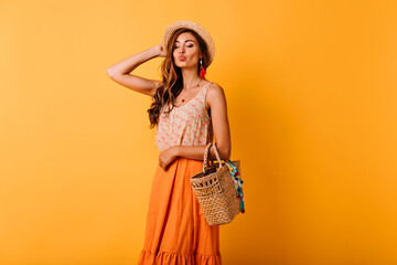 Jocund woman in summer skirt posing with kissing face expression. Indoor photo of relaxed elegant...