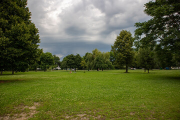 Fototapeta na wymiar Rain and hail clouds gathering over zagreb city, fast approaching over the shore of Jarun lake, popular spot for relaxation, sports and casual recreation in the green environment