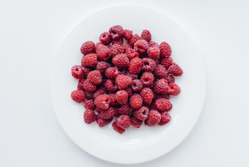 Red raspberry berries close-up on a white background. Healthy food, natural vitamins. Fresh berries