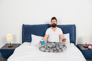 Fototapeta premium Man pajamas sit bed bedroom morning meditation, yoga exercises concept