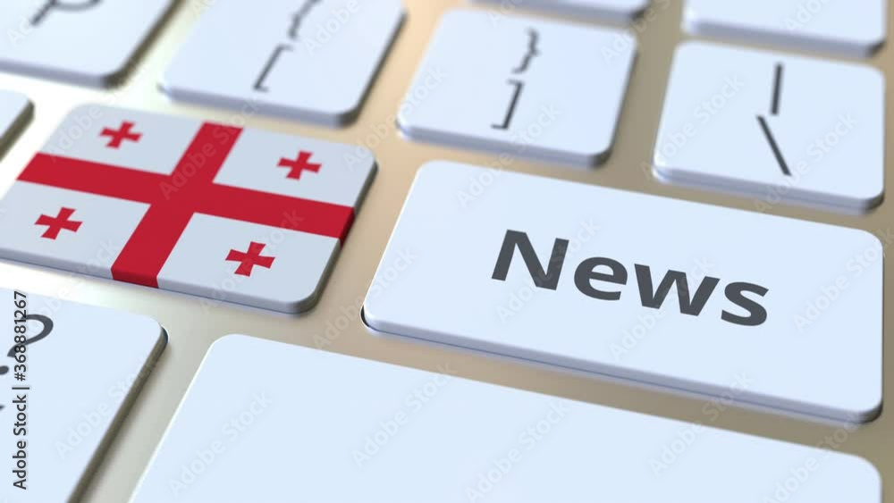 Poster news text and flag of georgia on the keys of a computer keyboard. national online media related conc