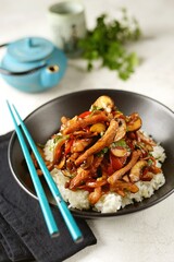 Fried meat with vegetables and mushrooms in Asian sauce. Asian spicy food.
