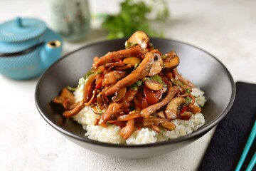 Fried meat with vegetables and mushrooms in Asian sauce. Asian spicy food.