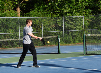 Obraz premium Ball Connects With Pickle Ball Racket