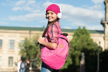 Fototapeta premium Instilling a sense of wanderlust. Happy girl travel with backpack urban outdoors. Audio library. Travel music. Traveling and wanderlust. Wanderlust concept. Summer vacation. School holidays