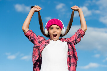 When my hair is long I go to hairdresser. Surprised girl hold hair tails on sunny blue sky. Beauty look of little child. Hair salon. Haircare cosmetics. Shampoo products. Tangle free care