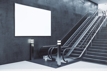 Escalator with blank banner on concrete wall.