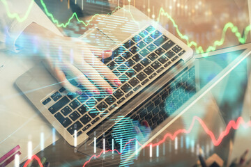 Naklejka premium Double exposure of woman hands typing on computer and financial graph hologram drawing. Stock market analysis concept.