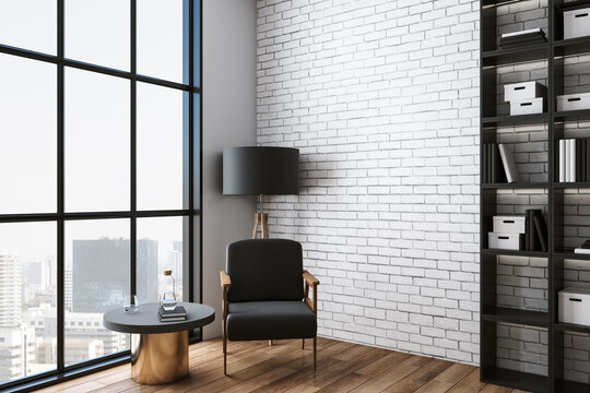 Cozy Living Room With Chair, Table, Shelf With Book And City View.