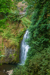 Fototapeta na wymiar Historic bridge over Multnomah Falls. It is a waterfall located in the Columbia River Gorge, east of Troutdale, between Corbett and Dodson, Oregon