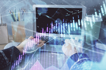 Double exposure of woman hands typing on computer and forex chart hologram drawing. Stock market invest concept.