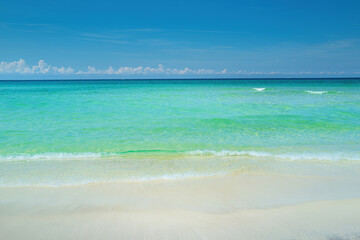 Fototapeta na wymiar Sand beach with blue ocean and cloudscape background.