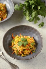 Couscous salad with radishes, cucumbers, carrots, cilantro, olive oil and wine vinegar. Healthly food.