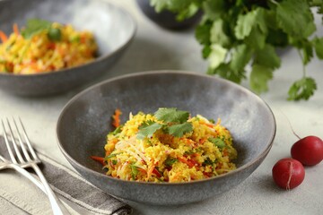 Couscous salad with radishes, cucumbers, carrots, cilantro, olive oil and wine vinegar. Healthly food.