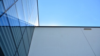Abstract image of looking up at modern glass and concrete building. Architectural exterior detail of office building. Industrial art and detail.