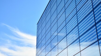 Fototapeta na wymiar Commercial building close up. Abstract texture of blue glass modern building. Business background.