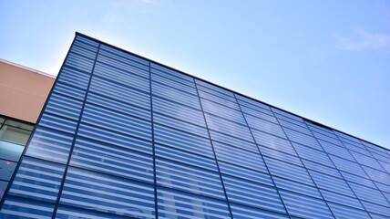 Fototapeta na wymiar Commercial building close up. Abstract texture of blue glass modern building. Business background.