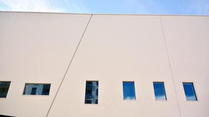 Abstract image of looking up at modern glass and concrete building. Architectural exterior detail of office building. Industrial art and detail.
