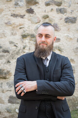 Man with long beard wears a dark elegant suit