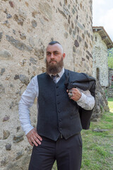 Man with long beard wears a dark elegant suit