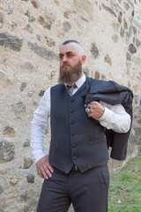 Man with long beard wears a dark elegant suit