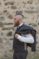 Man with long beard wears a dark elegant suit