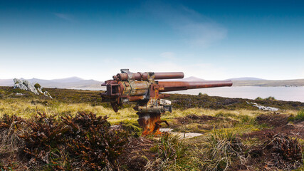 Rusting World War 2 naval mounted gun relic at Ordnance Point on a minefield from the Falklands War on East Falkland Island, Falkland Islands.