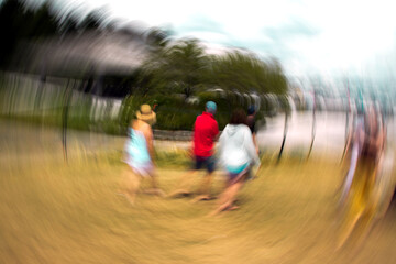 Bright photo with blurred view of group of people.