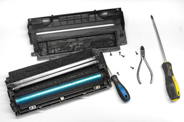 Disassembled laser printer cartridge for repair, cleaning and refilling.
