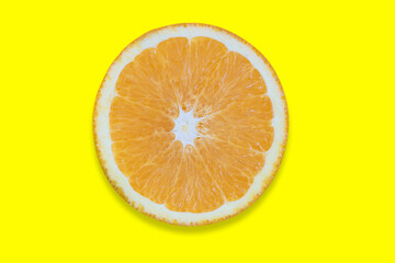 Orange cut into pieces isolated on yellow background. Close-up texture. Copy space. Clipping Path.