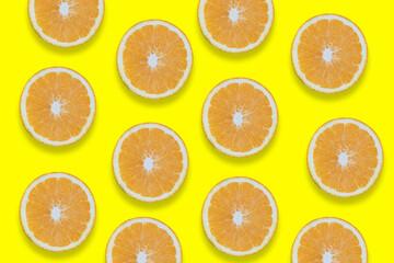 Oranges cut into pieces. Close-up texture. Copy space. Yellow background. Clipping Path.