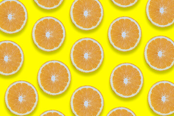 Oranges cut into pieces. Close-up texture. Copy space. Yellow background. Clipping Path.