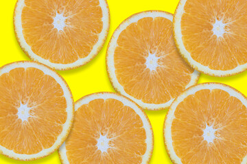 Oranges cut into pieces. Close-up texture. Copy space. Yellow background. Clipping Path.
