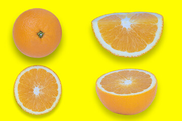 Oranges cut into pieces. Close-up texture. Copy space. Yellow background. Clipping Path.