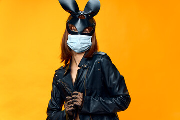  Female rabbit mask posing sexually in a medical mask from coronavirus