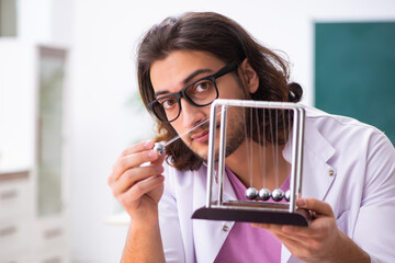 Young male physicist in the classroom