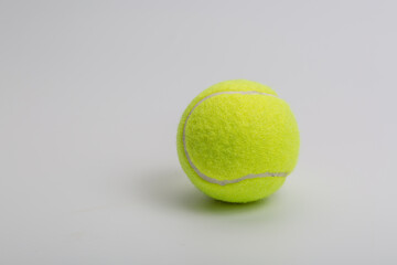 Green tennis ball and worker on white background