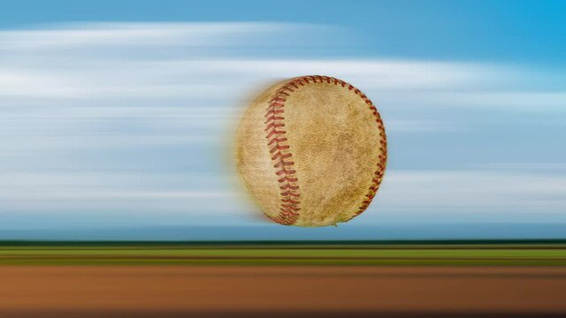 speed of one old leather baseball flying and rotating in the air on nature background