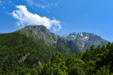 Obraz premium View of the beautiful countryside of North Ossetia. Sunny day. Beautiful summer landscape in the mountains. Grassy fields and hills. Rural landscapes