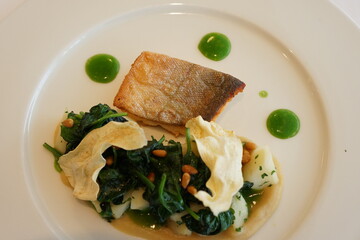Gourmet dish - Char fish, spinach and pine nuts