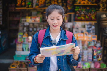 Young asian girl walking at Dumonoe saduak floating market, Thailand