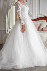 Fototapeta na wymiar The torso of a bride in a white wedding dress