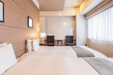 Twin bed and blanket in a small bedroom for couple people