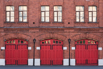 Fire station, an old historic brick building (1880s) with red gates. Fire department in Vasilyevsky...