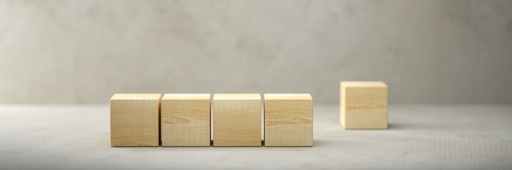 empty wooden cubes for own messages and icons on paper floor in front of a concrete wall