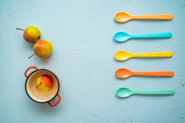 Small apples and colorful spoons, kids snacks 