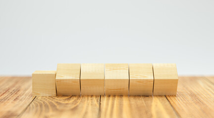 empty wooden cubes for own messages and icons on wooden floor and white background