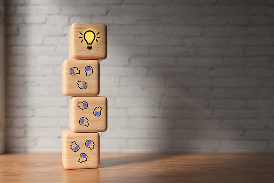 cubes showing a brainstorming session in front of a brick wall